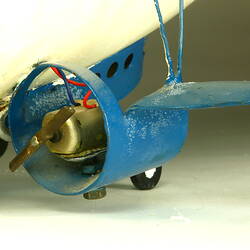 Detail of white model airship engine in small blue fin-like wing.