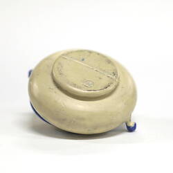 Side view of blank underside of tiny white pot.