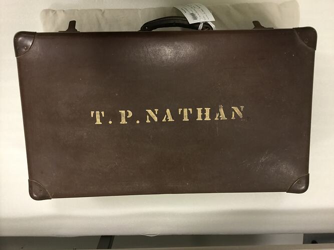 Brown case with gold lettering on side.