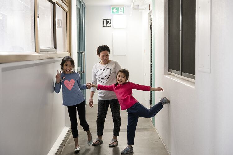 Public Housing Resident, Yith [Last Name Withheld], in a Hallway with her Daughters Kate and Sally during the COVID-19 Pandemic, Richmond, Victoria, 7 May 2020