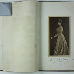 Image of inner pages opened, printed photographic image of woman on right, undersigned  'Lady Northcote 1907'