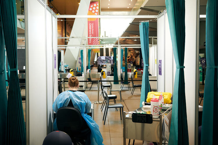 Staff member waiting for patients, St Vincent's Vaccination Hub, Melbourne Museum, 23 Sep 2021