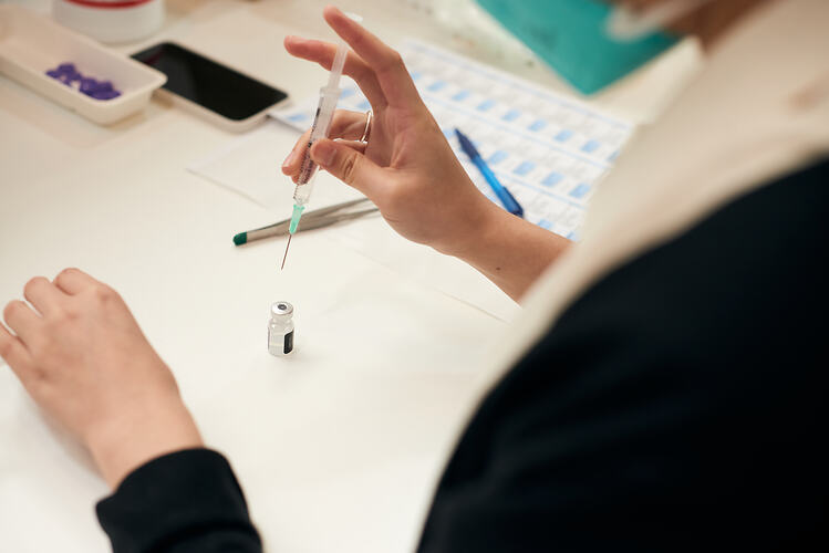 Preparing a Vaccine, St Vincent's Vaccination Hub, Melbourne Museum, 23 Sep 2021