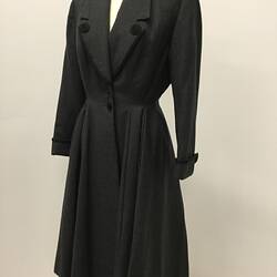 Long coat made from grey woollen fabric.