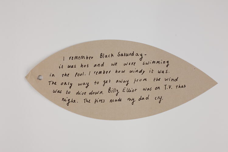 Pink paper leaf with handwritten text in black ink.