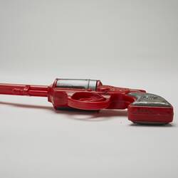 Red and grey plastic toy revolver, bottom view.