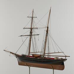 Black and red sailing ship model. Left profile.
