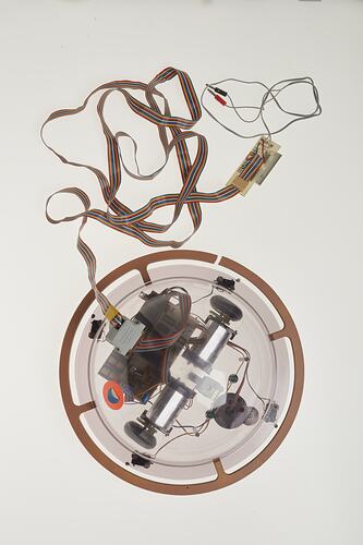 Top view of clear dome containing computer components. Cable attached.