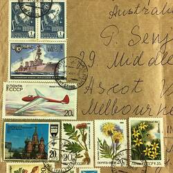 Detail of large brown envelope, covered with Soviet stamps dating between 1973 and 1986. Handwritten address.