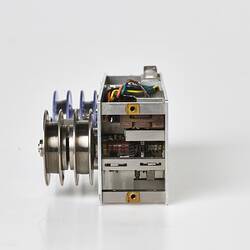 Small metal box two wired reels on top. One reel is blue plastic the other metal.