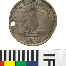 Round coin with raised text above and below a kangaroo. Hole punched on left side near edge.