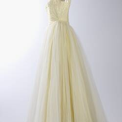 Side view, cream evening gown, yellow sequins.