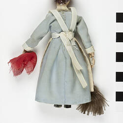 Female wooden doll dressed in servant outfit.