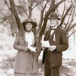 Man and woman, posed with trees behind.