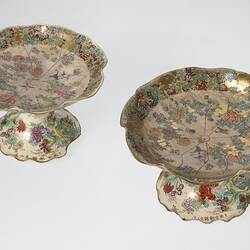 Pair of cream coloured compote with wavy edges decorated with birds & chrysanthemums.