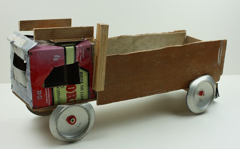 Toy truck made with found materials, side view.