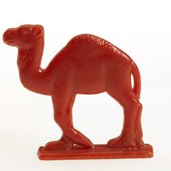 Red plastic toy camel facing left.