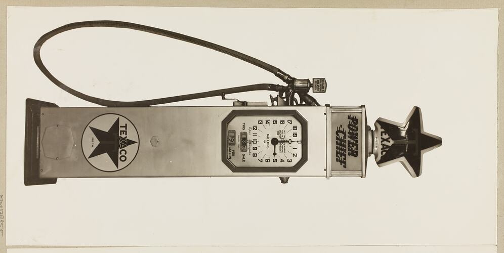 Monochrome photograph of an electric petrol pump.