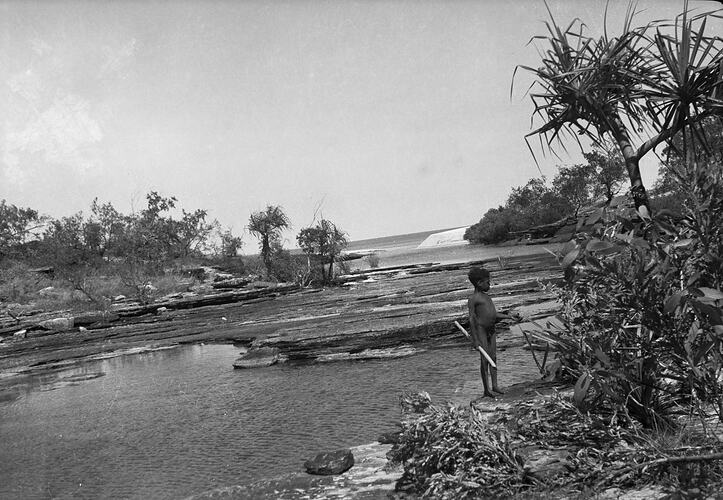 Unidentified child standing near a river, Milingimbi, Northern Territory,  late 1920s-30s