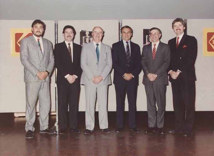 Row of six men  suits.
