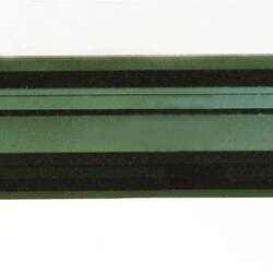 Long, narrow green crystal specimen.