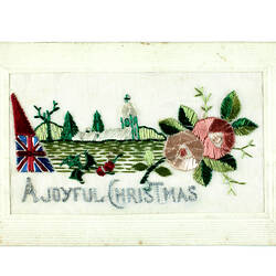 Front of embroidered postcard with country, flag and flowers.