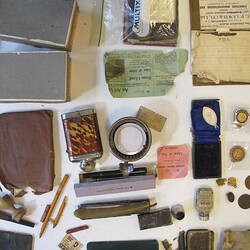 Contents of suitcase laid on bench.