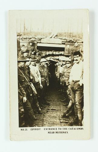 Soldiers standing outside the entrance to an underground dugout.