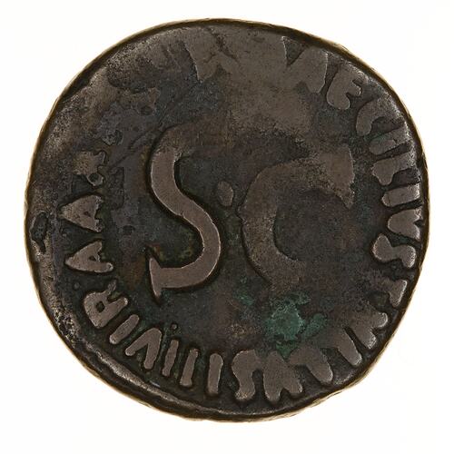 Round coin, aged, S.C. written in centre, more writing around the edge.