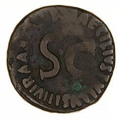 Round coin, aged, S.C. written in centre, more writing around the edge.