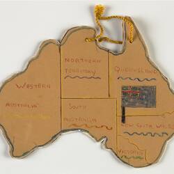 Australia-shaped orange card map with states outlined in pencil. Yellow tied cord at top.