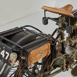 Motor cycle, right rear view angle. Number plate and satchel.
