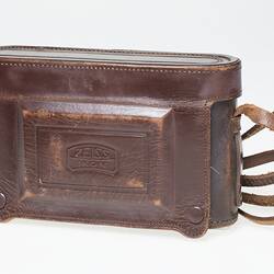 Brown leather camera case with strap.