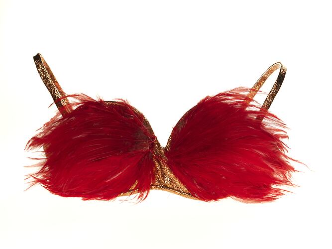 Red feathered brassiere with copper bra, straps.