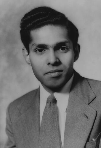 Half portrait of man wearing suit and tie.