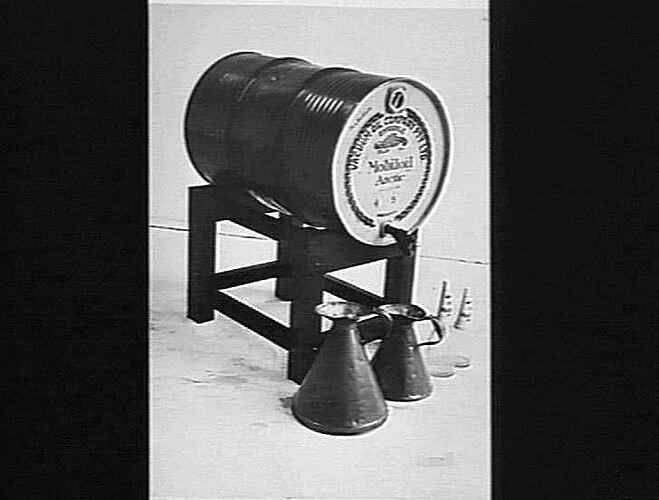 COPY OF THIS PHOTO SENT TO OTHER STATES SHOWING HOW TO USE 44 GALLON DRUMS OF OIL: JUNE 1941