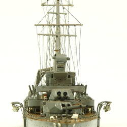 Naval ship with two masts, front view.