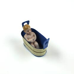 Toy metal tub with baby inside.