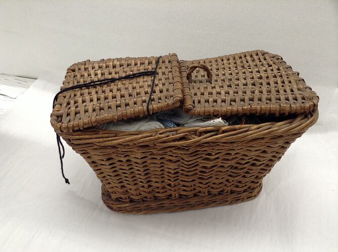 Twin lid woven sewing basket.