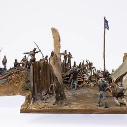 Model of figurines representing soldiers and miners engaged in fighting.