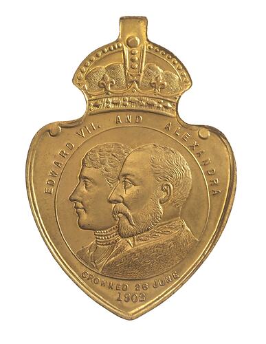 Shield shaped medal with crown and loop at top. Has conjoined busts of Edward VII and Queen Alexandra.