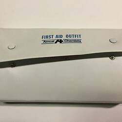 Closed white first aid kit showing brand on cover in green and blue.