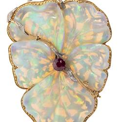 White opal, gold and silver brooch in the shape of a flower.