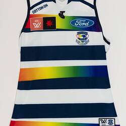 Women's AFLW guernsey with horizontal navy, white and rainbow stripes. Laying flat.