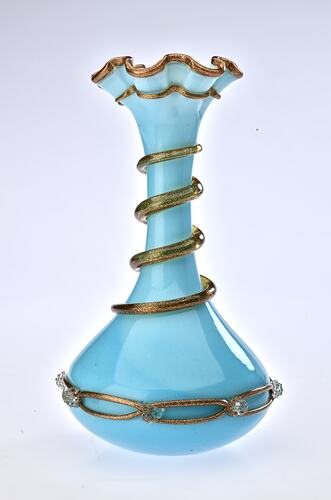 Pale blue opaque glass vase with gilded ribbon spiralling from base up to top. Flared neck with frill at top.