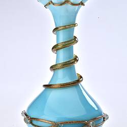 Pale blue opaque glass vase with gilded ribbon spiralling from base up to top. Flared neck with frill at top.