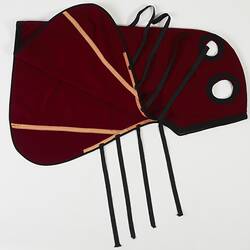 Red and black woollen horse hood. Four straps. Two cut out holes.