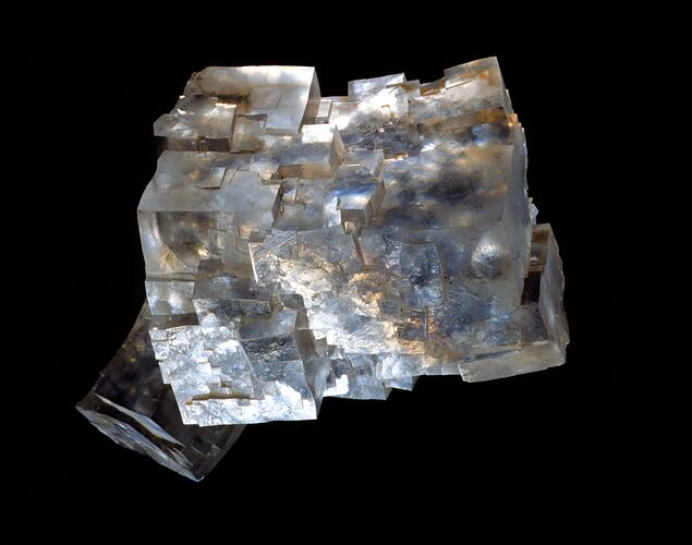 Clear iridescent cube-like crystal specimen.