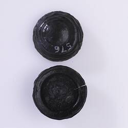 Tektites that look like glassy black buttons.