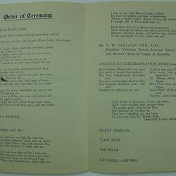 Open book page on green paper with printed text.